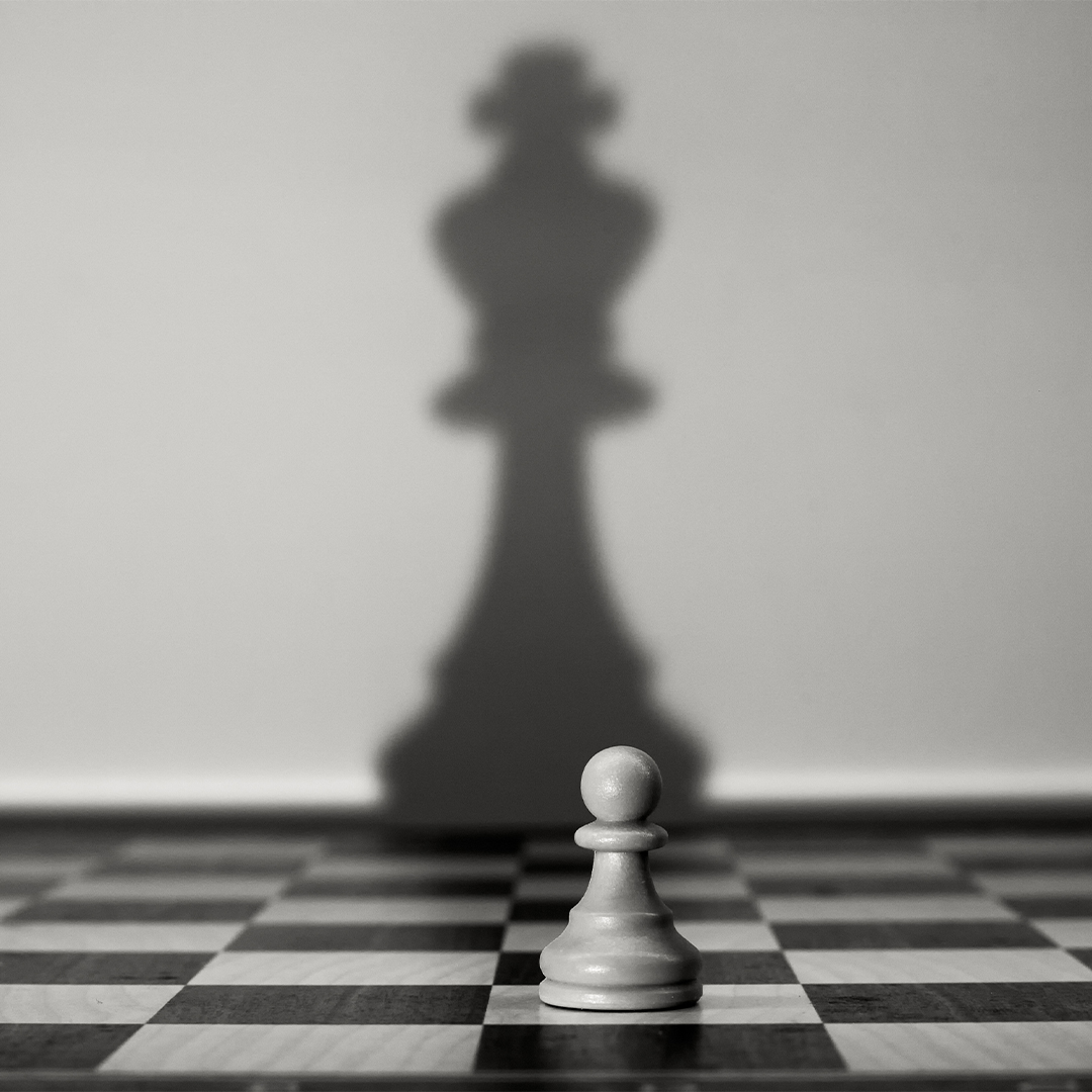 Chessboard with one pawn - the shadow the pawn is casting is a king piece - Odgers Executive Search Board Headhunters