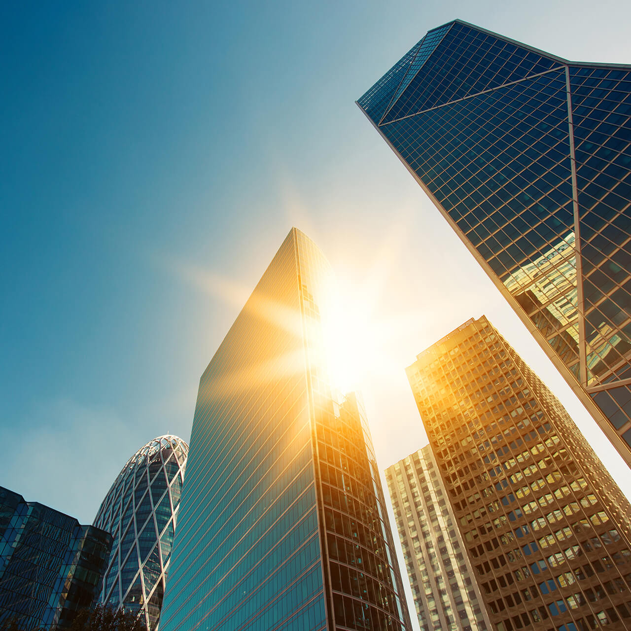odgers berndtson - sun showing through office buildings in London