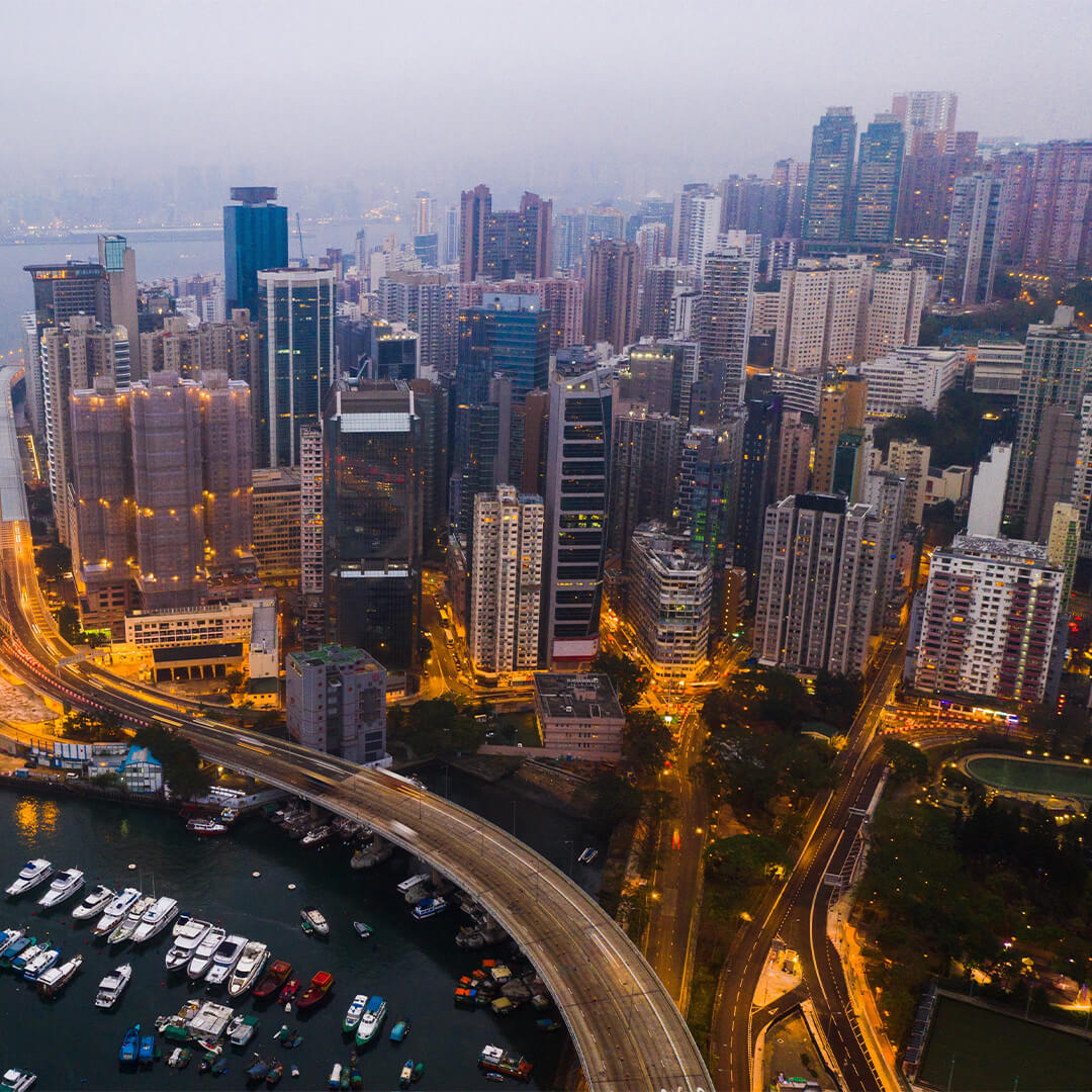 Arial view of city with office buildings and streets lit up - Odgers Executive Search Board Headhunters